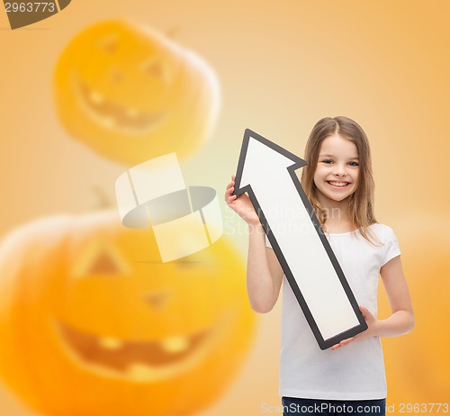 Image of smiling little girl holding big white arrow
