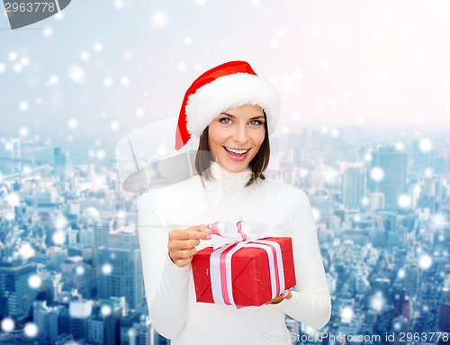 Image of smiling woman in santa helper hat with gift box