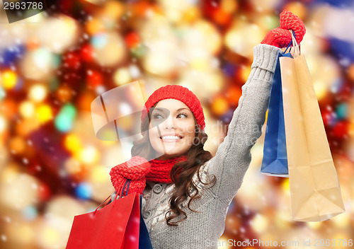 Image of asian woman in winter clothes with shopping bags