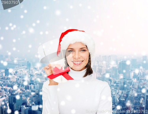Image of smiling woman in santa helper hat and jingle bells