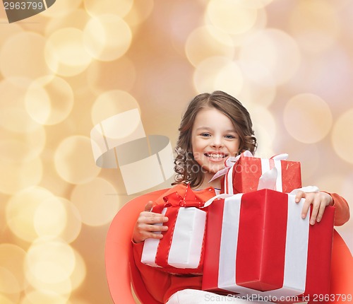 Image of smiling little girl with gift boxes