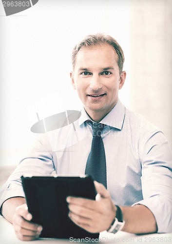 Image of businessman with tablet pc in office