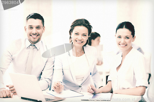 Image of business team discussing something in office