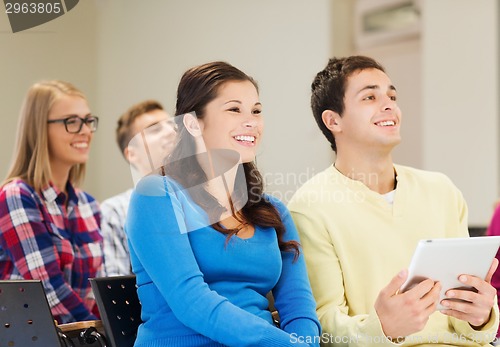 Image of group of smiling students with tablet pc