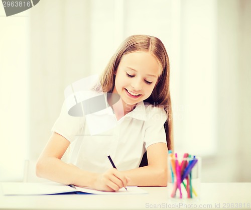 Image of little student girl drawing at school