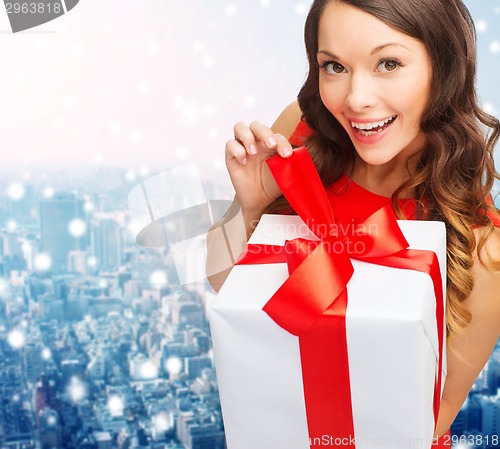 Image of smiling woman in red dress with gift boxes