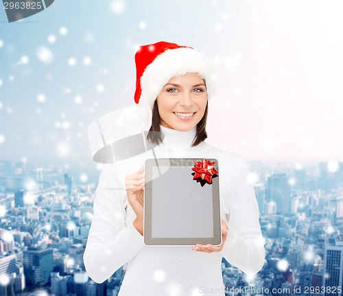Image of woman in santa helper hat with tablet pc