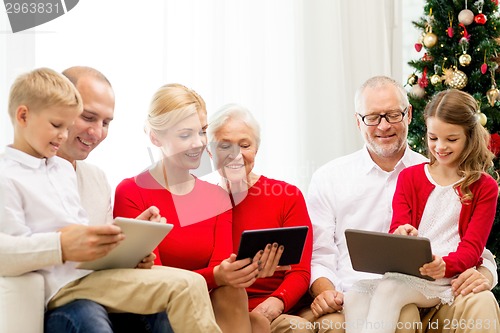 Image of smiling family with tablet pc computers at home