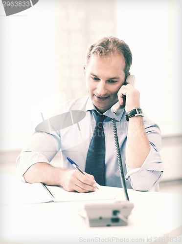 Image of handsome businessman talking on the phone