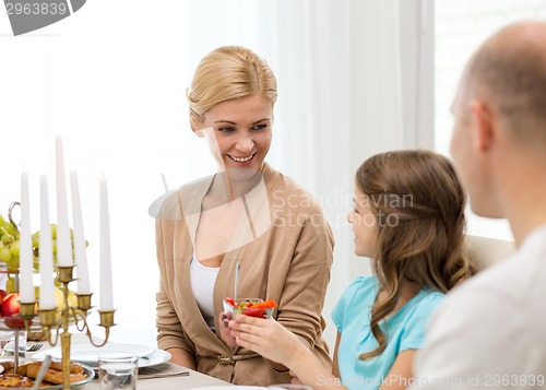 Image of smiling family having holiday dinner at home