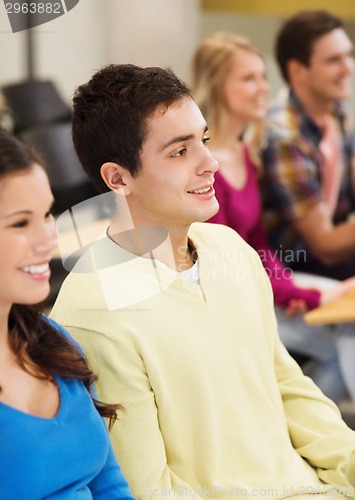 Image of group of smiling students in lecture hall