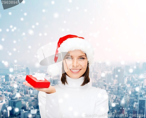 Image of smiling woman in santa helper hat with gift box