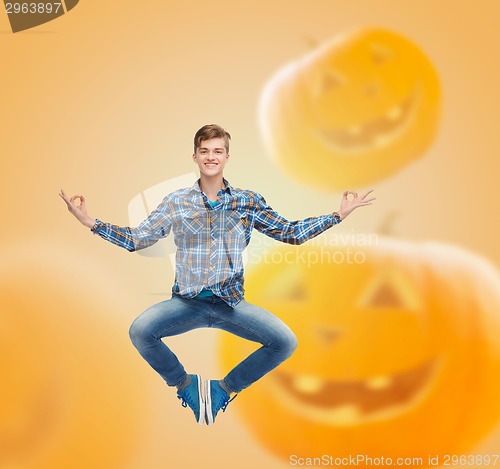 Image of smiling young man jumping in air