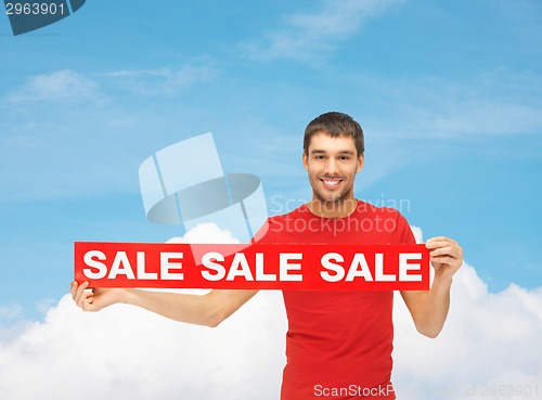 Image of man in red t-shirt with sale sign
