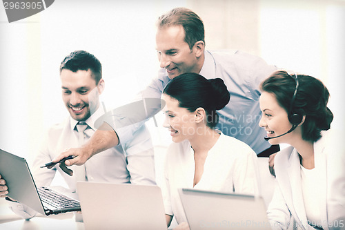 Image of group of people working in call center