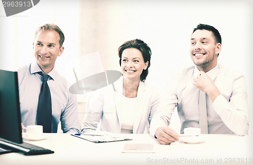 Image of business team discussing something in office