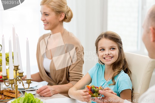 Image of smiling family having holiday dinner at home