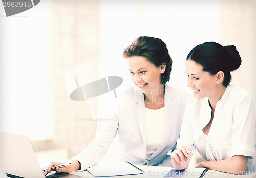 Image of businesswomen working with laptop in office