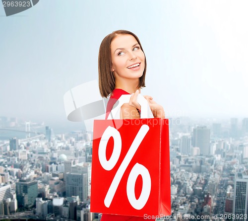 Image of woman in red dress with shopping bags