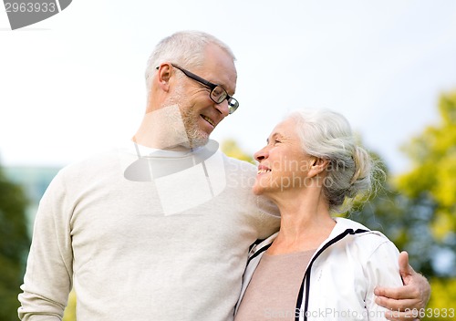 Image of senior couple hugging in city park