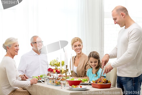 Image of smiling family having holiday dinner at home