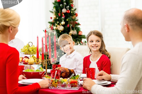 Image of smiling family having holiday dinner at home