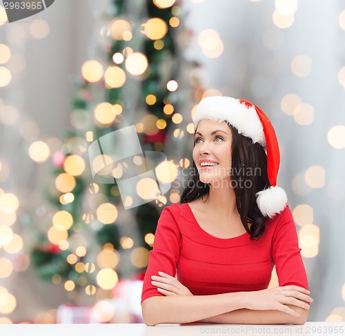 Image of smiling woman in santa helper hat