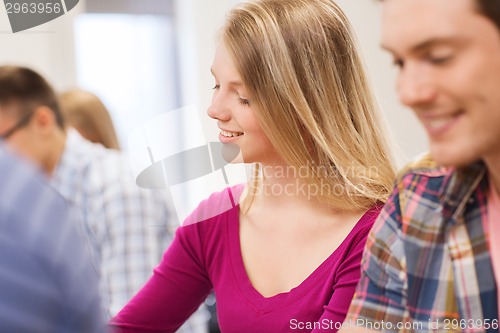 Image of group of smiling students in lecture hall
