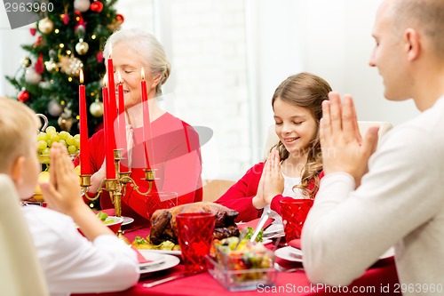 Image of smiling family having holiday dinner at home