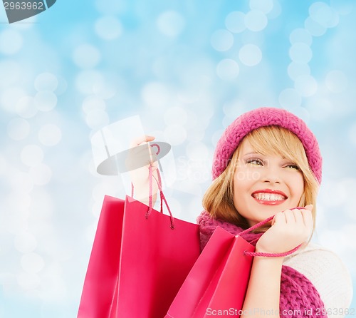Image of smiling young woman with shopping bags