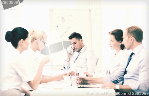 Image of stressed male boss on business meeting