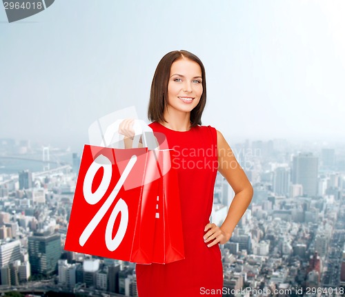 Image of woman in red dress with shopping bags