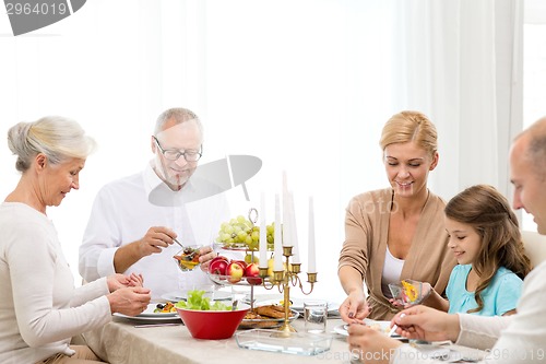Image of smiling family having holiday dinner at home