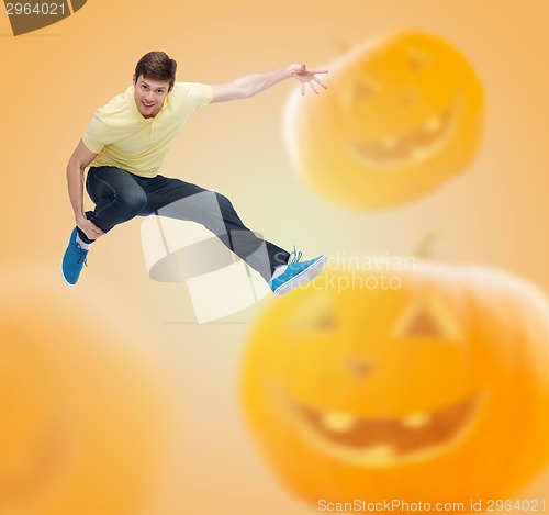 Image of smiling young man jumping in air