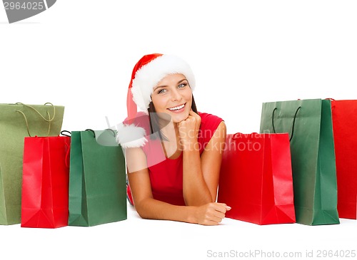 Image of woman in red shirt with shopping bags