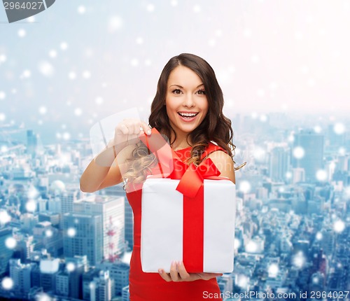 Image of smiling woman in red dress with gift boxes
