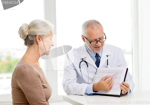 Image of smiling senior woman and doctor meeting