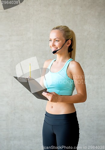 Image of beautiful athletic woman in gym