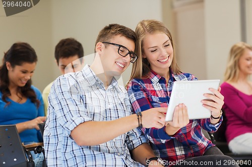 Image of group of smiling students with tablet pc