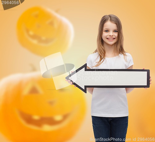 Image of smiling little girl holding big white arrow