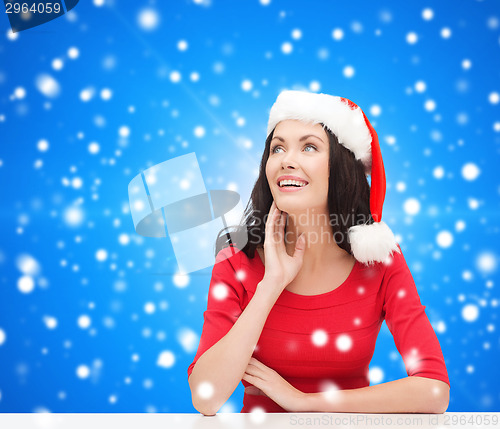 Image of smiling woman in santa helper hat