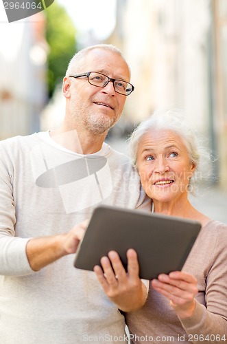 Image of senior couple photographing on city street