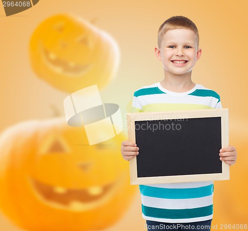 Image of smiling little boy with black board
