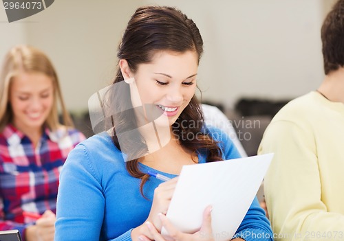 Image of group of smiling students with notebook