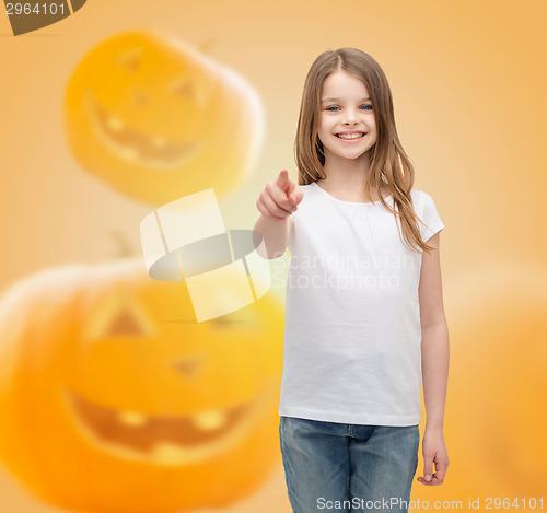 Image of smiling girl over pumpkins background