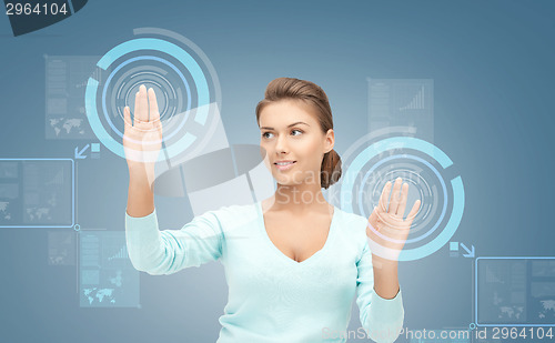 Image of smiling businesswoman working with virtual screen