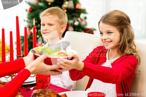 Image of smiling family having holiday dinner at home
