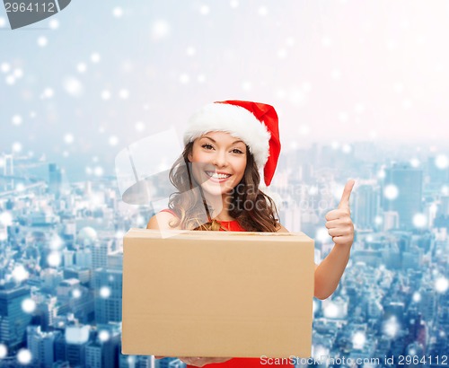 Image of smiling woman in santa helper hat with parcel box