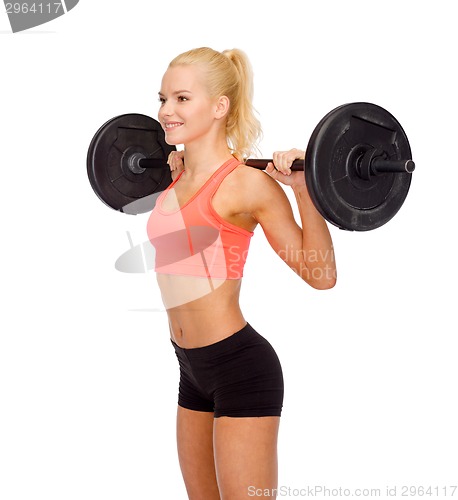 Image of smiling sporty woman exercising with barbell