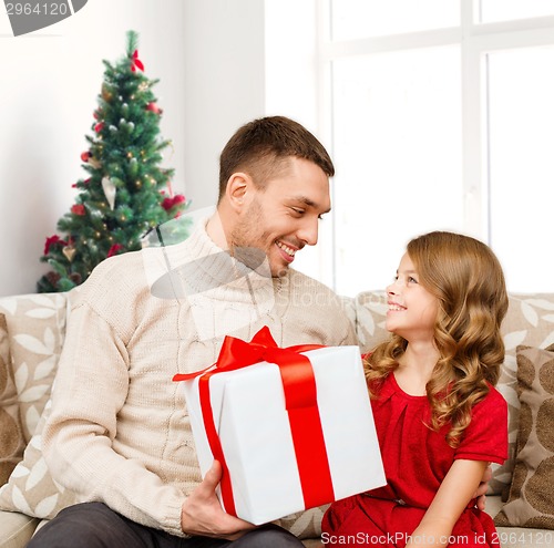 Image of smiling father and daughter with gift box